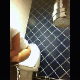 A hidden camera records a girl with curly hair bending over to take a piss. Next, she lays out a seat protector, sits down on the toilet and takes a shit. Pooping sounds are difficult to hear. Camera is way off center. About 3 minutes.